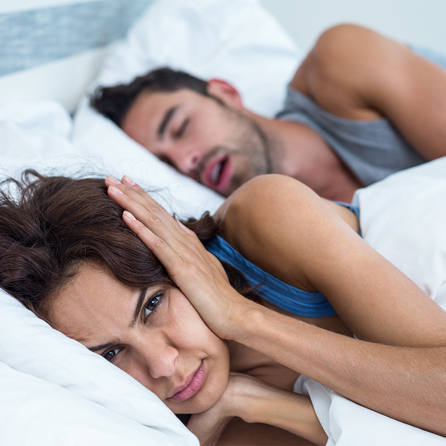 Frau kann nicht schlafen, weil ihr Mann schnarcht